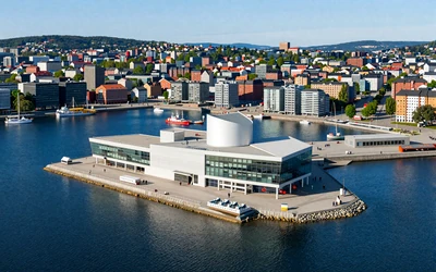 Oslo waterfront with modern Opera House and harbor on a bright summer day