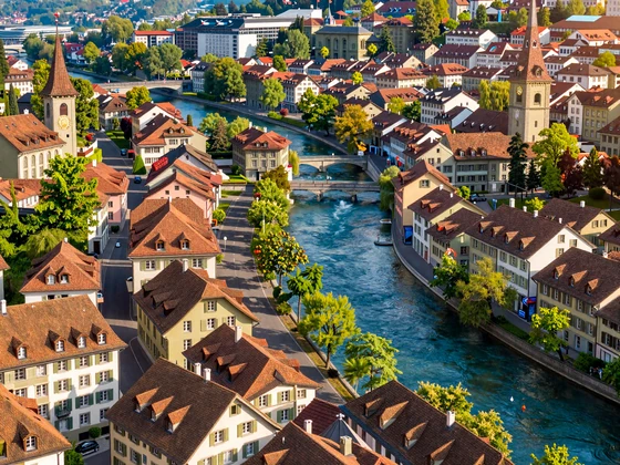 Aerial view of Bern old town with Aare river and terracotta rooftops in warm afternoon light