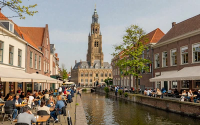 Utrecht old town with Dom Tower and canal-side café terraces in spring