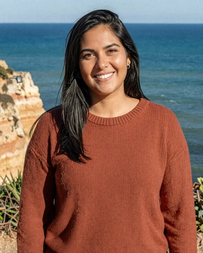 Ines, 31, Portuguese woman on the Algarve coast wearing a terracotta sweater