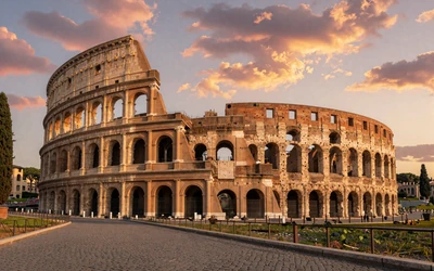 The Roman Colosseum at golden hour with warm sunset light and Mediterranean atmosphere