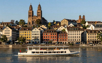 Basel Rhine riverfront with colorful buildings and Basel Minster cathedral at golden hour