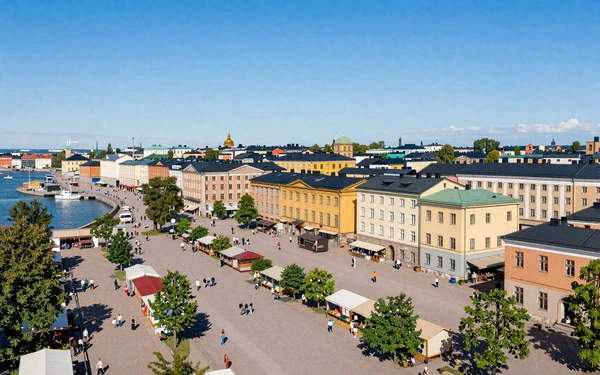 Helsinki market square with colorful stalls near harbor and historic Nordic buildings on a summer day