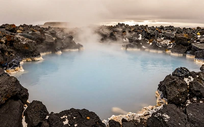 Iconic Blue Lagoon geothermal spa in Iceland with milky blue water and volcanic rocks
