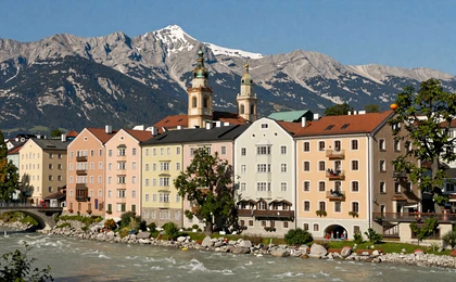 Innsbruck colorful medieval buildings along Inn River with Nordkette mountains behind