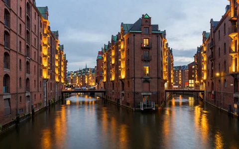 Hamburg Speicherstadt warehouse district at dusk with red brick buildings and canal reflections