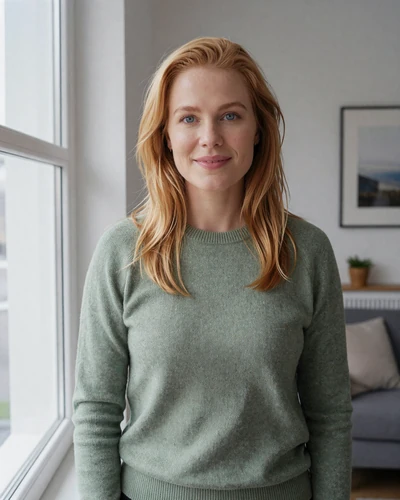 Ingrid, 33, Norwegian woman from Oslo with strawberry blonde hair in a Scandinavian-styled living room